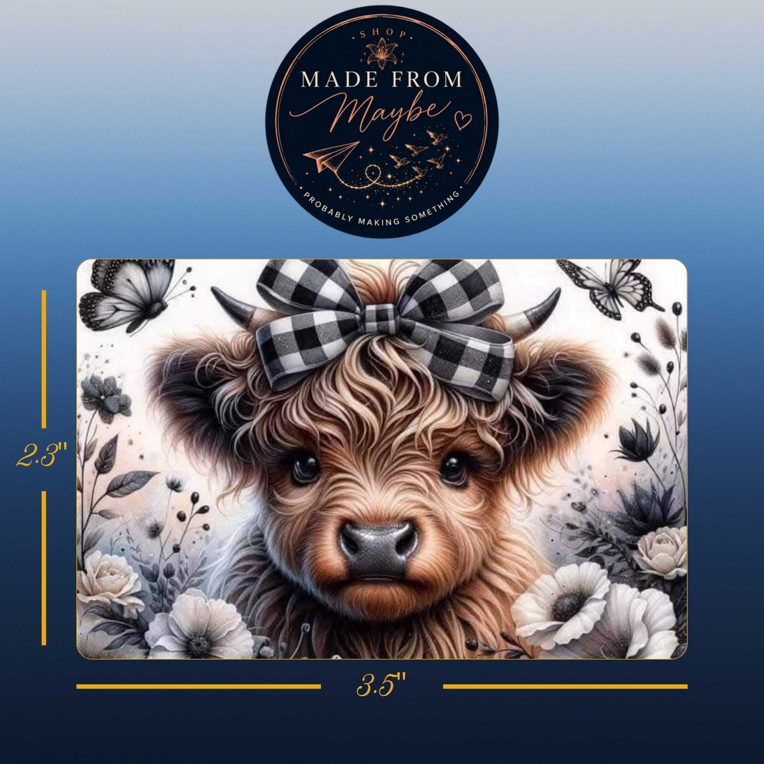 A rectangular decorative print or sign featuring a close-up illustration of a fluffy brown cow with a black-and-white gingham bow, surrounded by butterflies and flowers. The image includes dimension labels of 2.